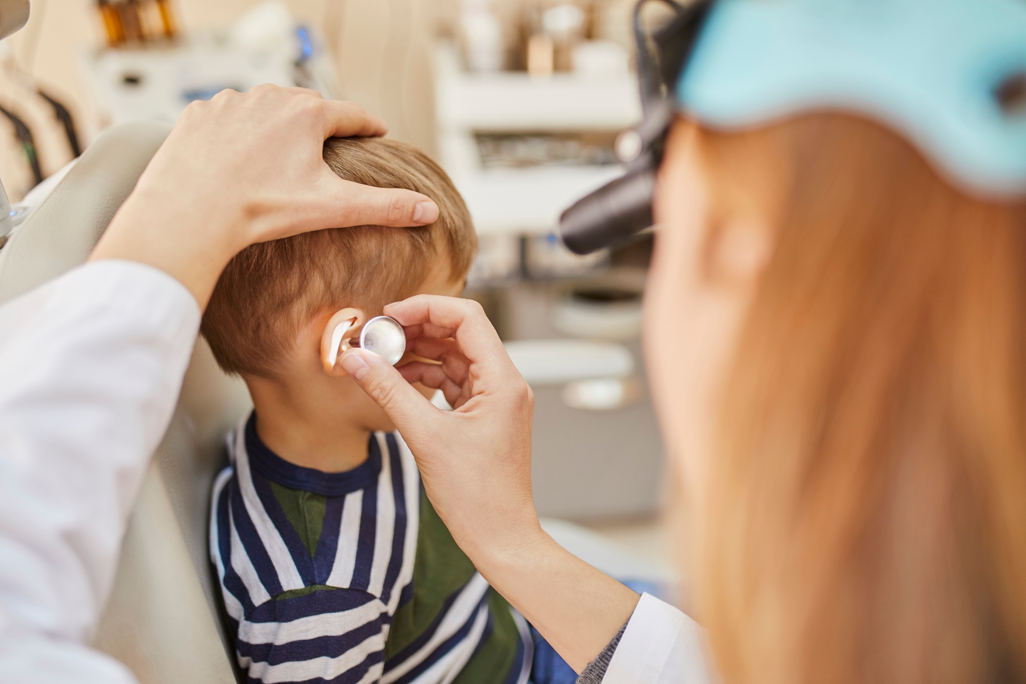 ENT physician examining ear of a boy